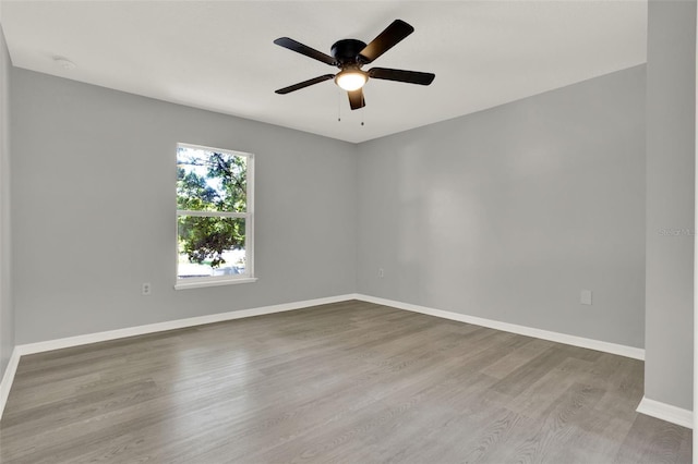 809 Deer Glen Ct, Fruitland Park, FL 34731 - unfurnished room with wood finished floors, baseboards, and a ceiling fan