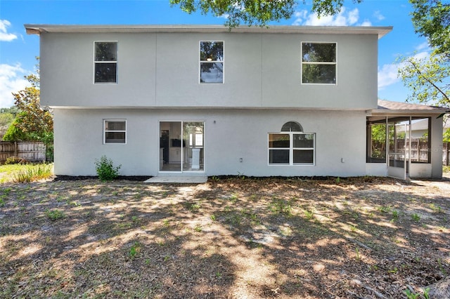 809 Deer Glen Ct, Fruitland Park, FL 34731 - rear view of house with a sunroom and stucco siding
