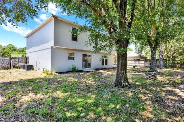 809 Deer Glen Ct, Fruitland Park, FL 34731 - back of house with a fenced backyard, stucco siding, and central AC unit