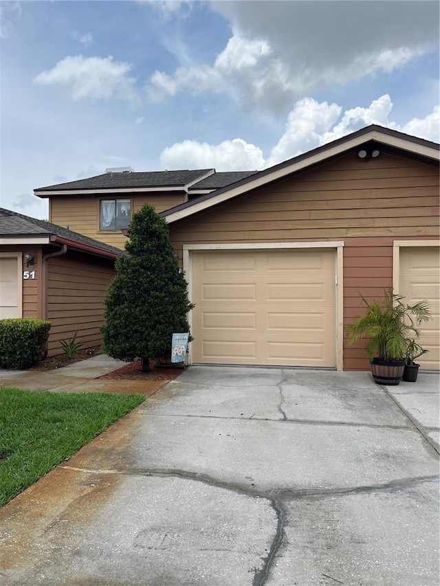 707 Carpenters Way Unit 50, Lakeland, FL 33809 - view of front of house featuring concrete driveway and a garage