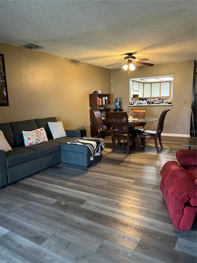 707 Carpenters Way Unit 50, Lakeland, FL 33809 - living room with ceiling fan, wood finished floors, and a textured ceiling