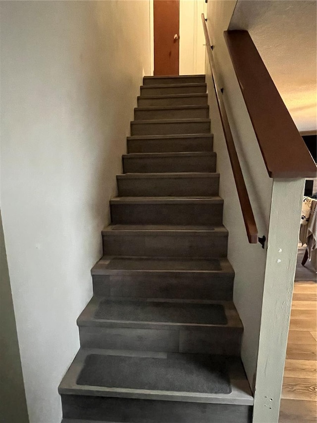 707 Carpenters Way Unit 50, Lakeland, FL 33809 - stairway featuring wood finished floors