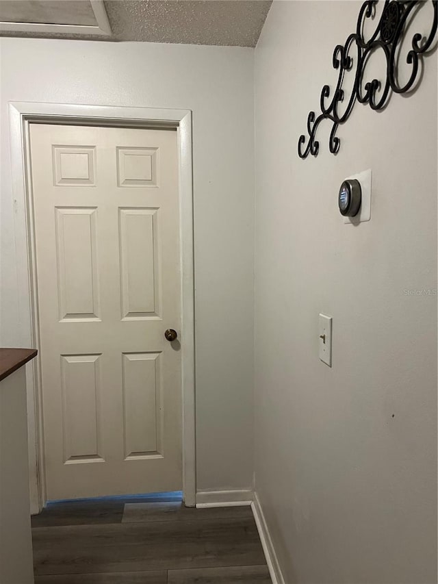 707 Carpenters Way Unit 50, Lakeland, FL 33809 - corridor with dark wood finished floors and baseboards