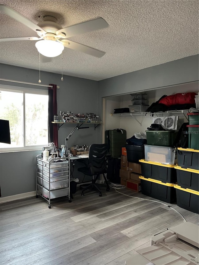 707 Carpenters Way Unit 50, Lakeland, FL 33809 - office area featuring a textured ceiling, a ceiling fan, and wood finished floors