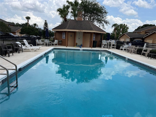 707 Carpenters Way Unit 50, Lakeland, FL 33809 - community pool with a patio and an outdoor structure
