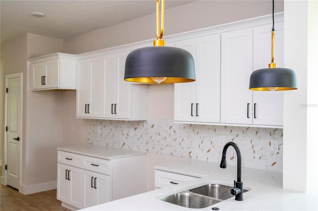 33 W 7th St, Apopka, FL 32703 - kitchen with a sink, tasteful backsplash, and hanging light fixtures