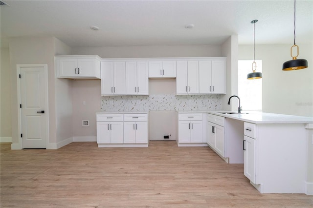 33 W 7th St, Apopka, FL 32703 - kitchen featuring a sink, white cabinets, and light wood-style flooring