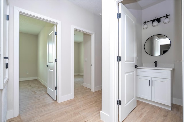 33 W 7th St, Apopka, FL 32703 - bathroom featuring wood finished floors, vanity, and baseboards