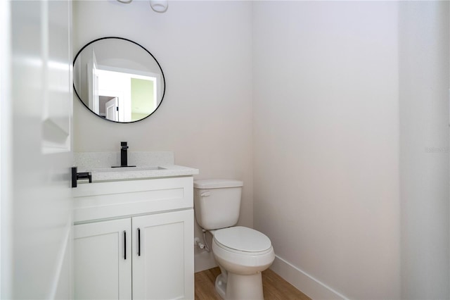 33 W 7th St, Apopka, FL 32703 - half bath featuring wood finished floors, vanity, toilet, and baseboards