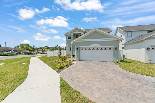 701 Dennis Ave, Orlando, FL 32807 - traditional home with decorative driveway, stucco siding, and an attached garage