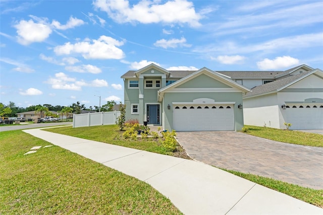 701 Dennis Ave, Orlando, FL 32807 - view of front of home featuring decorative driveway, stucco siding, and a garage