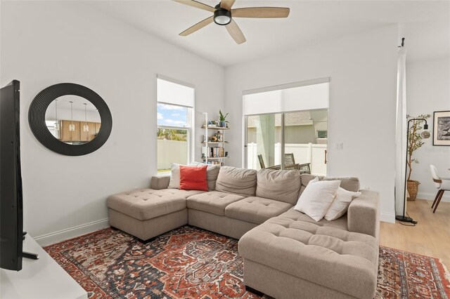 701 Dennis Ave, Orlando, FL 32807 - living area featuring ceiling fan, light wood finished floors, and baseboards