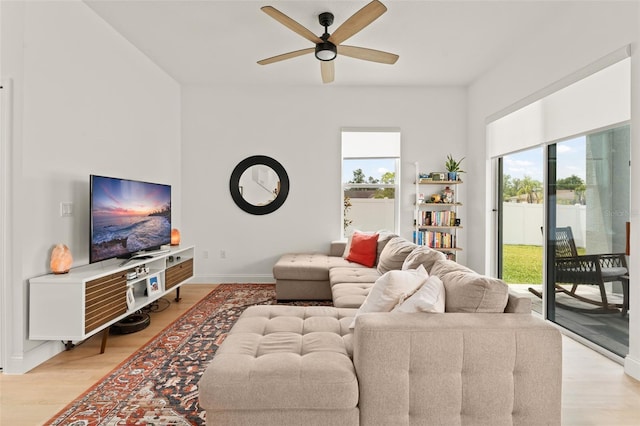 701 Dennis Ave, Orlando, FL 32807 - living area with ceiling fan, light wood finished floors, and baseboards