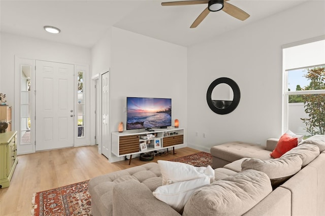 701 Dennis Ave, Orlando, FL 32807 - living room with light wood finished floors, a ceiling fan, and baseboards