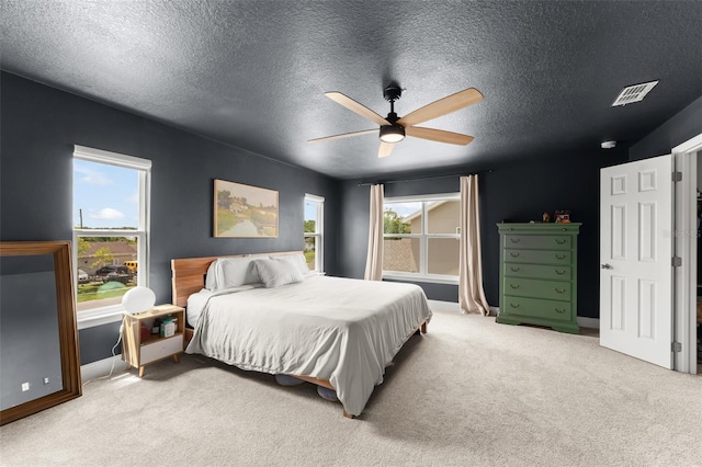 701 Dennis Ave, Orlando, FL 32807 - bedroom featuring a textured ceiling, light carpet, baseboards, and ceiling fan