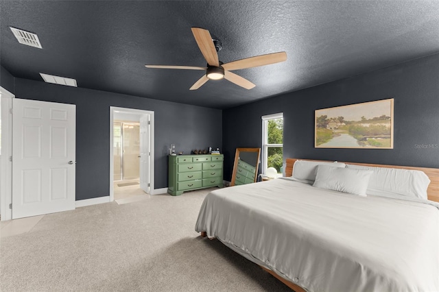 701 Dennis Ave, Orlando, FL 32807 - carpeted bedroom with a textured ceiling, connected bathroom, ceiling fan, and baseboards