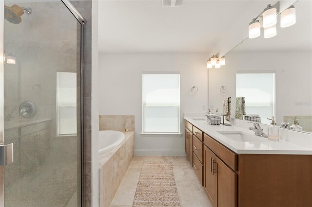 701 Dennis Ave, Orlando, FL 32807 - bathroom with double vanity, a garden tub, a shower stall, and tile patterned flooring