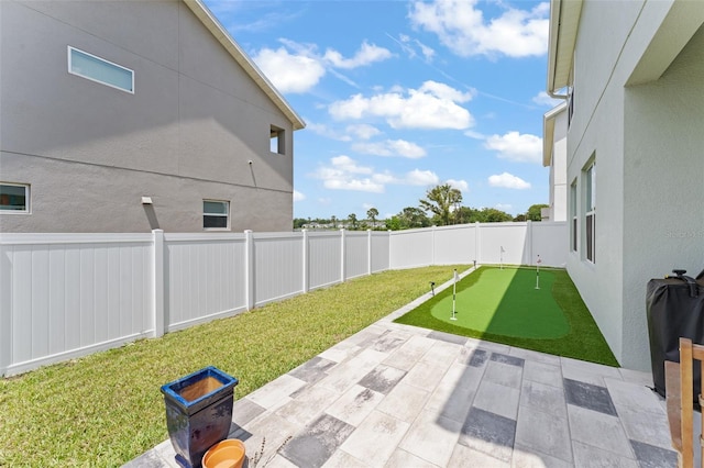 701 Dennis Ave, Orlando, FL 32807 - view of yard featuring a putting area and a patio area