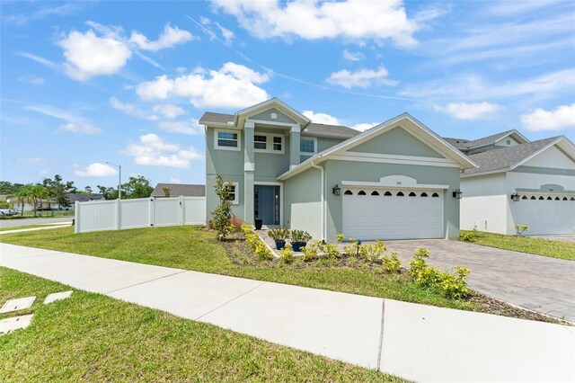701 Dennis Ave, Orlando, FL 32807 - view of front of property featuring stucco siding, a garage, and decorative driveway
