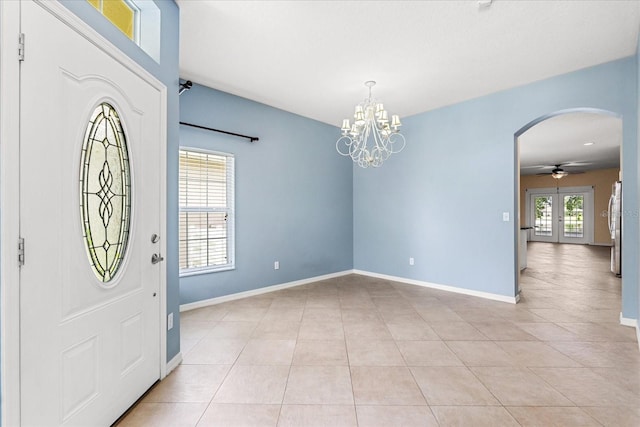 9644 Myrtle Creek Ln, Orlando, FL 32832 - entryway with arched walkways, baseboards, a chandelier, and light tile patterned floors