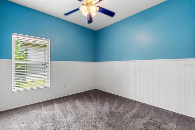 9644 Myrtle Creek Ln, Orlando, FL 32832 - empty room featuring a wainscoted wall, healthy amount of natural light, ceiling fan, and carpet