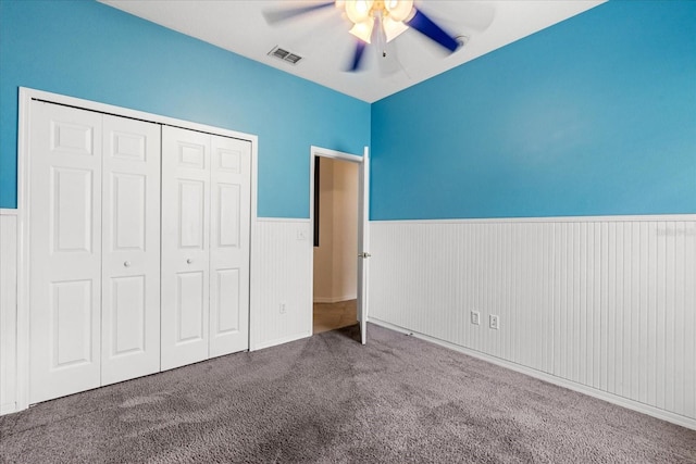 9644 Myrtle Creek Ln, Orlando, FL 32832 - unfurnished bedroom with a wainscoted wall, carpet floors, a closet, and a ceiling fan