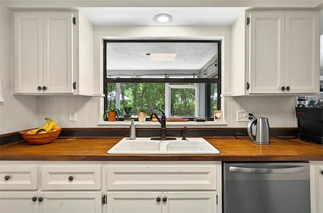 1202 Marshall Ct, Eustis, FL 32726 - kitchen featuring dishwasher, butcher block counters, a sink, and white cabinetry