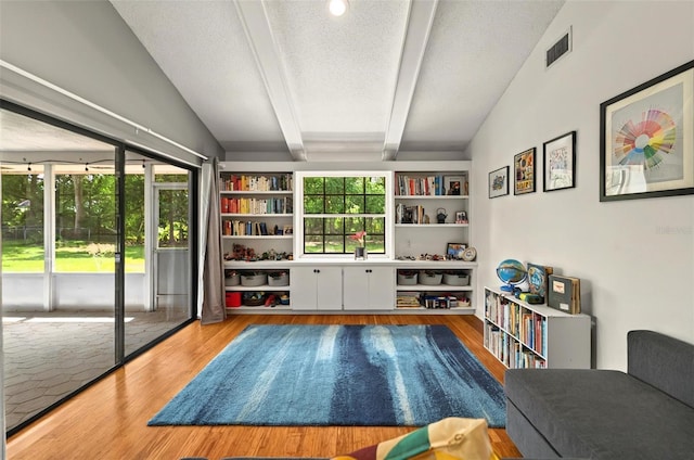 1202 Marshall Ct, Eustis, FL 32726 - sitting room featuring wood finished floors, healthy amount of natural light, and a textured ceiling