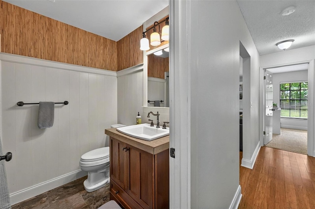 1202 Marshall Ct, Eustis, FL 32726 - bathroom with wood finished floors, baseboards, vanity, and toilet