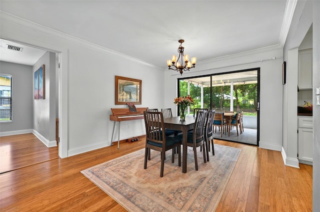 1202 Marshall Ct, Eustis, FL 32726 - dining space featuring a chandelier, crown molding, light wood-type flooring, and baseboards
