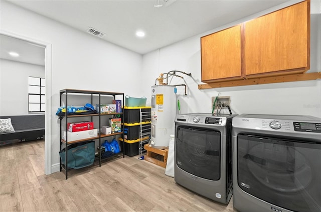 1202 Marshall Ct, Eustis, FL 32726 - washroom featuring electric water heater, cabinet space, light wood finished floors, washing machine and dryer, and recessed lighting