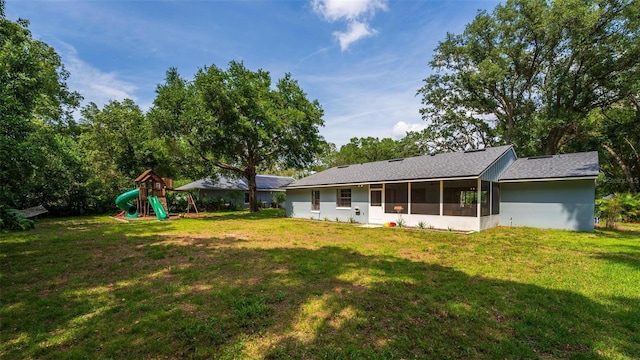 1202 Marshall Ct, Eustis, FL 32726 - rear view of property featuring a playground, a lawn, and a sunroom