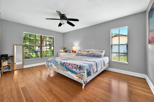 1202 Marshall Ct, Eustis, FL 32726 - bedroom featuring multiple windows, baseboards, and wood finished floors
