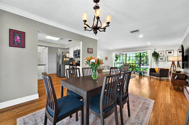 1202 Marshall Ct, Eustis, FL 32726 - dining area with wood finished floors, crown molding, a chandelier, baseboards, and recessed lighting
