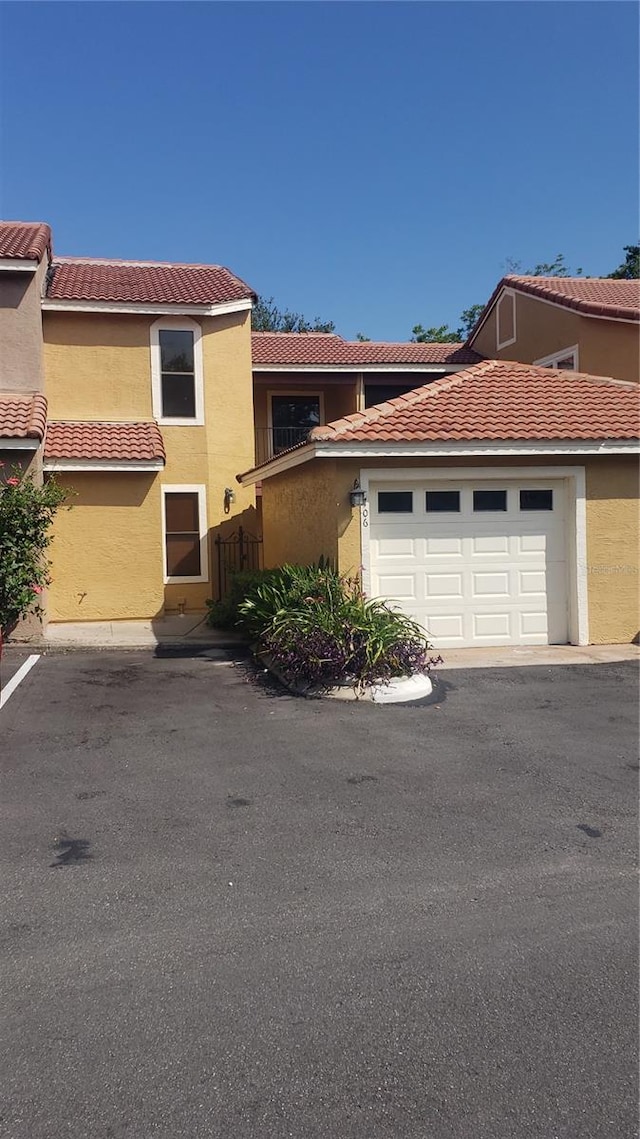 706 Lighthouse Ct, Altamonte Springs, FL 32714 - view of front of property featuring stucco siding, a garage, and a tiled roof