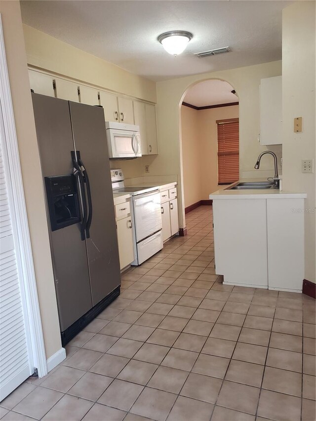 706 Lighthouse Ct, Altamonte Springs, FL 32714 - kitchen with white appliances, a sink, arched walkways, light countertops, and baseboards