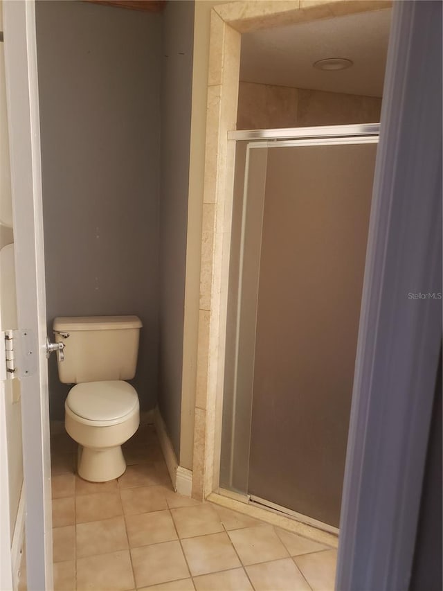 706 Lighthouse Ct, Altamonte Springs, FL 32714 - bathroom with toilet, tile patterned floors, a shower stall, and baseboards