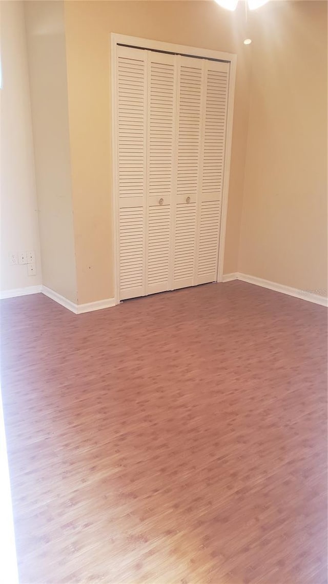 706 Lighthouse Ct, Altamonte Springs, FL 32714 - unfurnished bedroom featuring wood finished floors, baseboards, and a closet