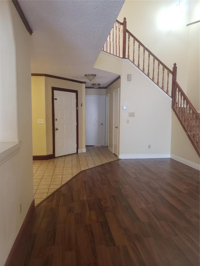 706 Lighthouse Ct, Altamonte Springs, FL 32714 - unfurnished living room featuring wood finished floors, stairway, a textured ceiling, baseboards, and ornamental molding