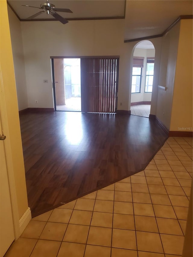 706 Lighthouse Ct, Altamonte Springs, FL 32714 - empty room with arched walkways, ceiling fan, wood finished floors, baseboards, and ornamental molding