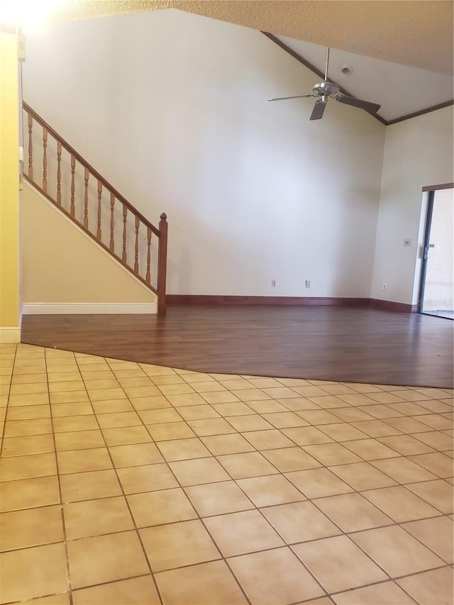 706 Lighthouse Ct, Altamonte Springs, FL 32714 - unfurnished living room featuring wood finished floors, a ceiling fan, high vaulted ceiling, stairs, and baseboards