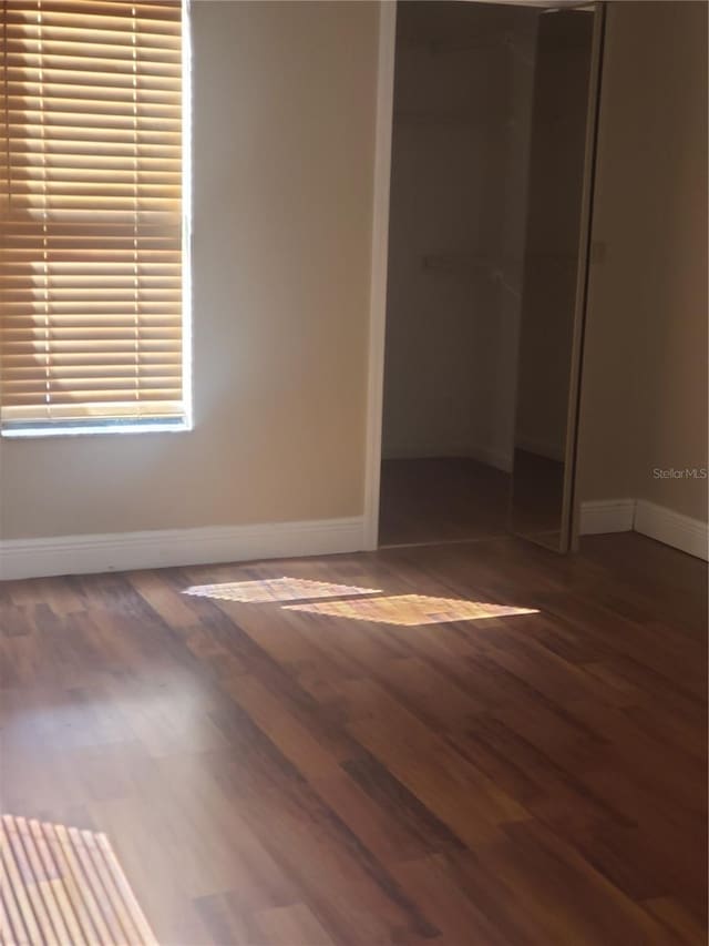 706 Lighthouse Ct, Altamonte Springs, FL 32714 - unfurnished bedroom featuring a closet, wood finished floors, and baseboards