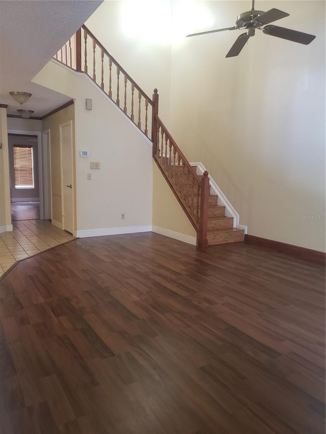 706 Lighthouse Ct, Altamonte Springs, FL 32714 - unfurnished living room with stairs, wood finished floors, ceiling fan, and baseboards