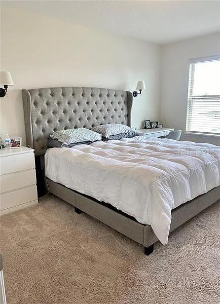 16391 Admirals Cove Ln, Winter Garden, FL 34787 - bedroom featuring light colored carpet