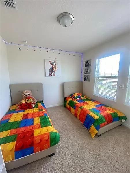 16391 Admirals Cove Ln, Winter Garden, FL 34787 - bedroom featuring multiple windows, carpet floors, and baseboards