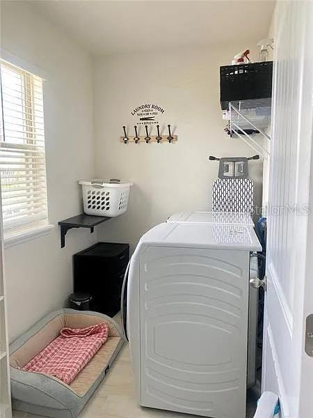 16391 Admirals Cove Ln, Winter Garden, FL 34787 - washroom with washing machine and clothes dryer and plenty of natural light