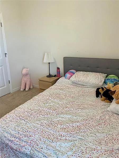 16391 Admirals Cove Ln, Winter Garden, FL 34787 - carpeted bedroom featuring baseboards