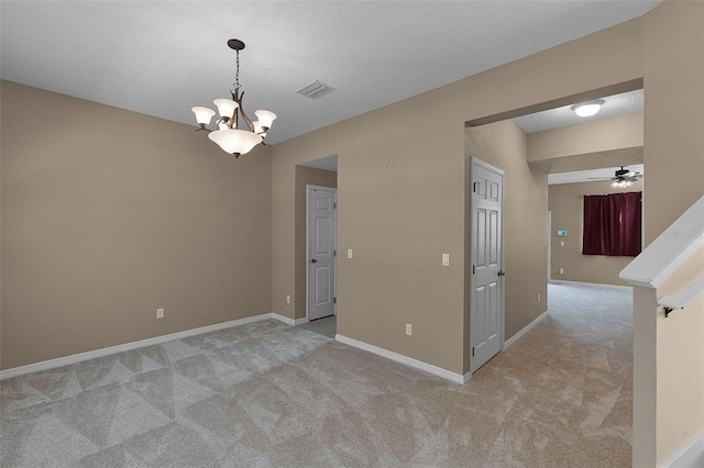 12335 Cruxbury Dr, Windermere, FL 34786 - empty room featuring light colored carpet, ceiling fan, and a chandelier