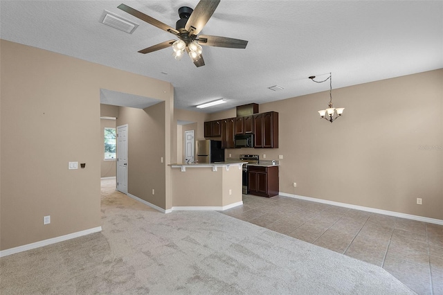 12335 Cruxbury Dr, Windermere, FL 34786 - kitchen with freestanding refrigerator, dark brown cabinets, light countertops, a chandelier, and ceiling fan