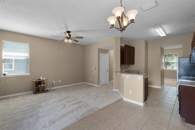 12335 Cruxbury Dr, Windermere, FL 34786 - kitchen featuring light countertops, a ceiling fan, a textured ceiling, light tile patterned floors, and a chandelier